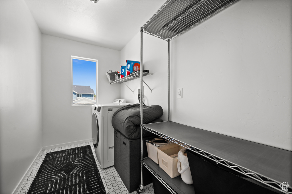 Washroom with washer and dryer and baseboards