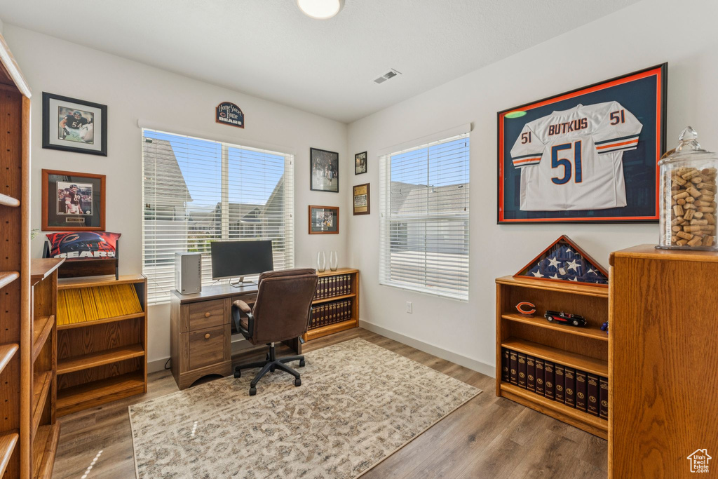 Home office featuring wood finished floors and baseboards