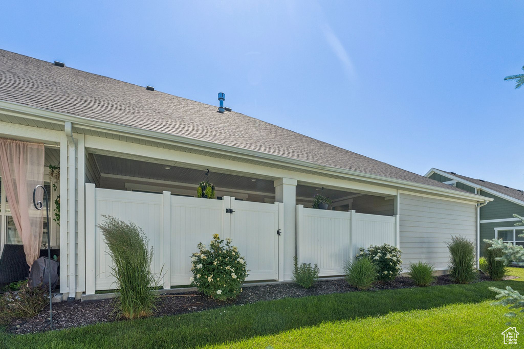 View of side of property featuring roof with shingles