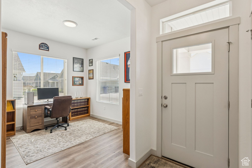Home office featuring light wood finished floors and baseboards