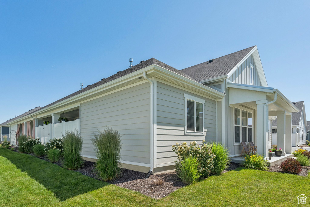 View of side of property featuring roof with shingles