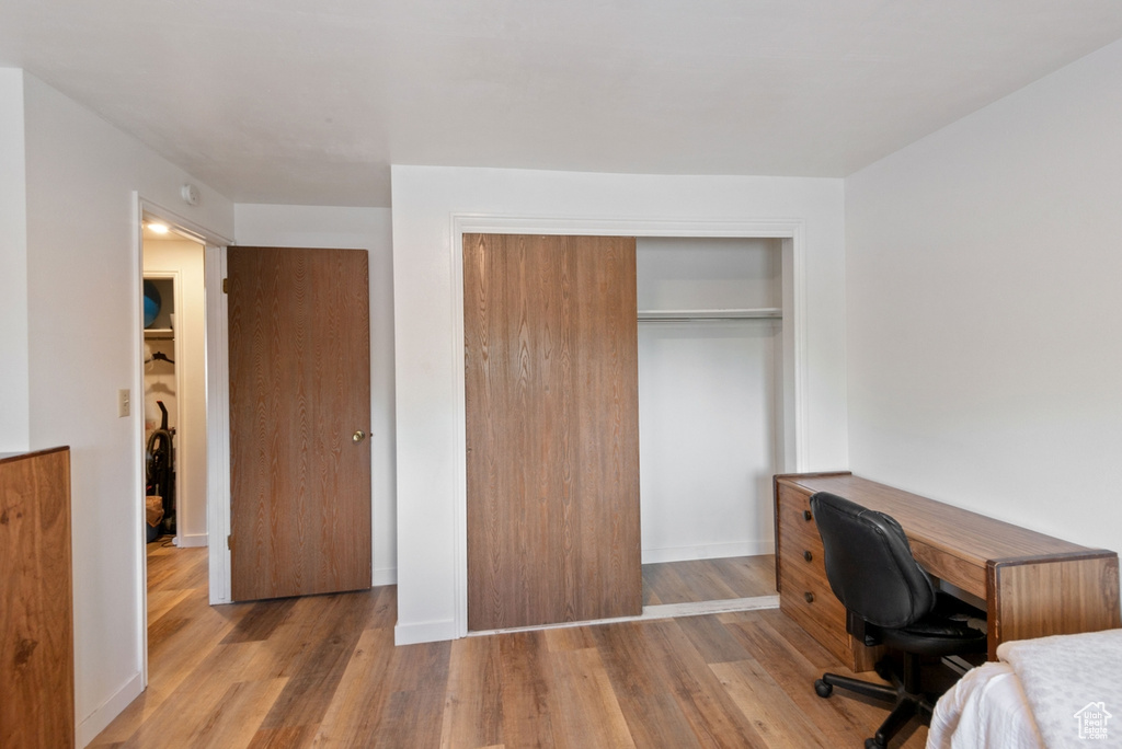 Home office with wood finished floors