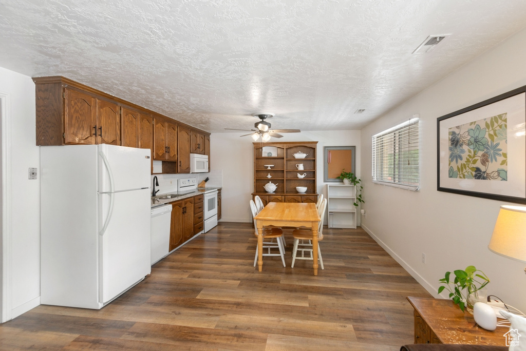 Dining room with a ceiling fan and dark wood-type flooring