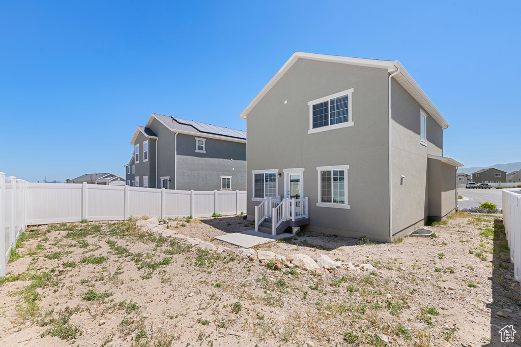 Back of property featuring a fenced backyard