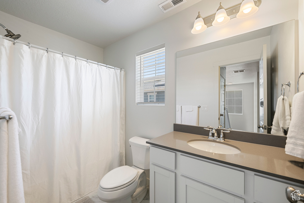Bathroom with vanity and curtained shower