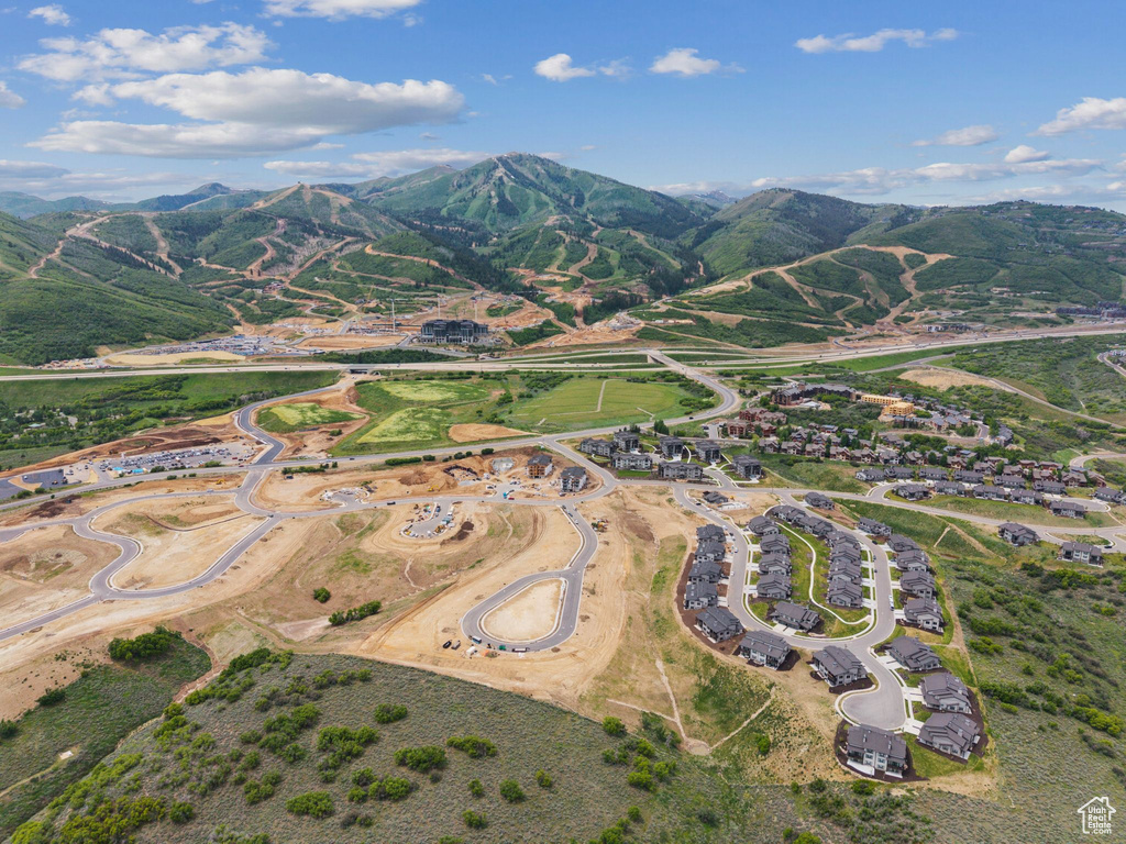 Aerial view of property's location with a mountainous background