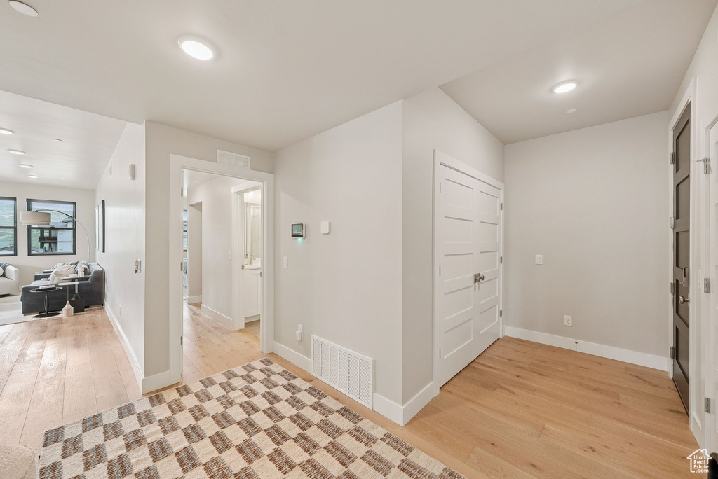 Foyer featuring light wood-style floors and baseboards