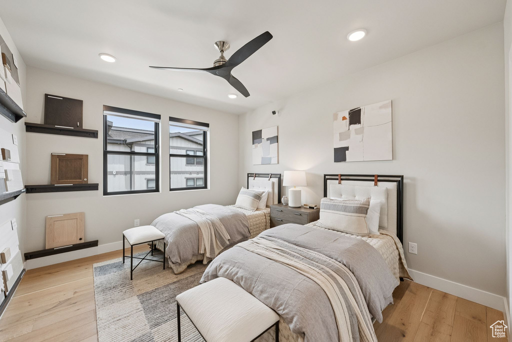 Bedroom featuring light wood finished floors, a ceiling fan, and recessed lighting