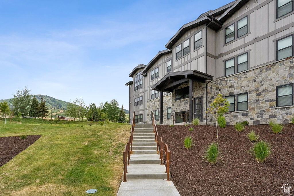 View of building exterior featuring stairs and a mountain view