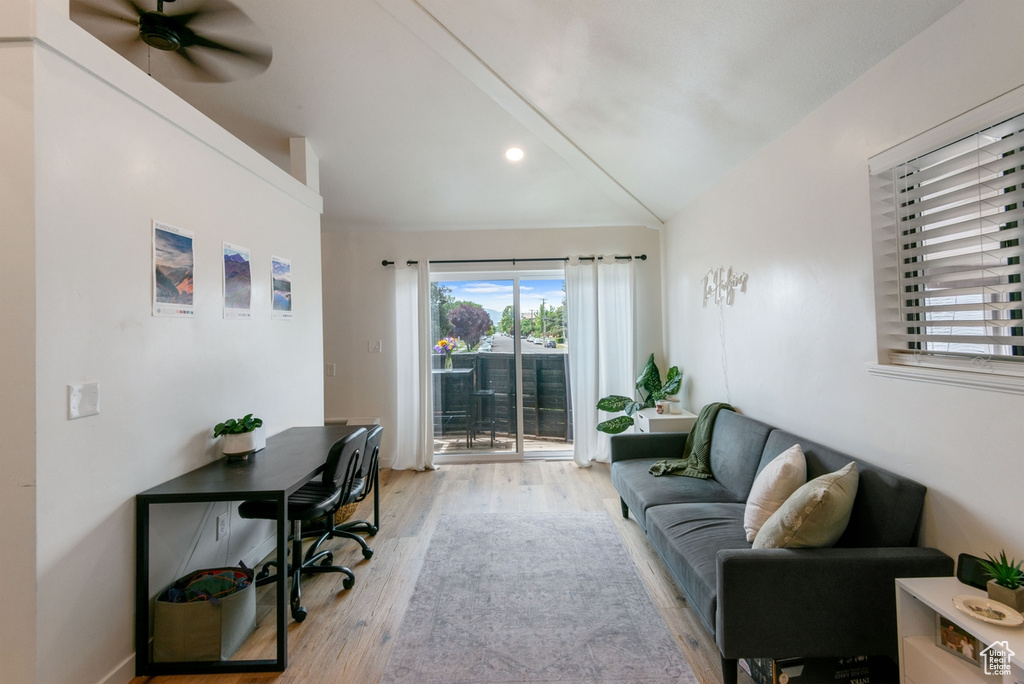 Living room featuring light wood-style flooring, ceiling fan, recessed lighting, and vaulted ceiling