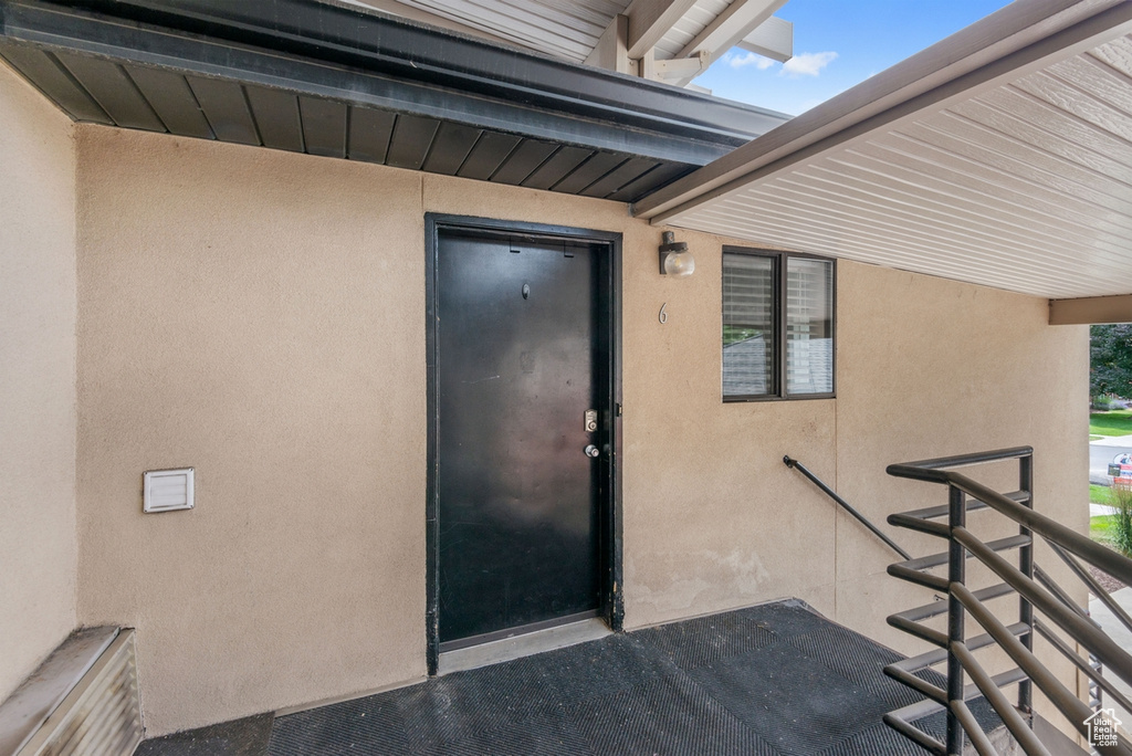Property entrance featuring stucco siding