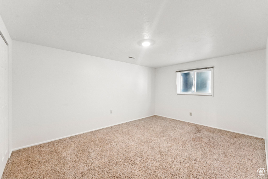 Spare room with carpet and baseboards