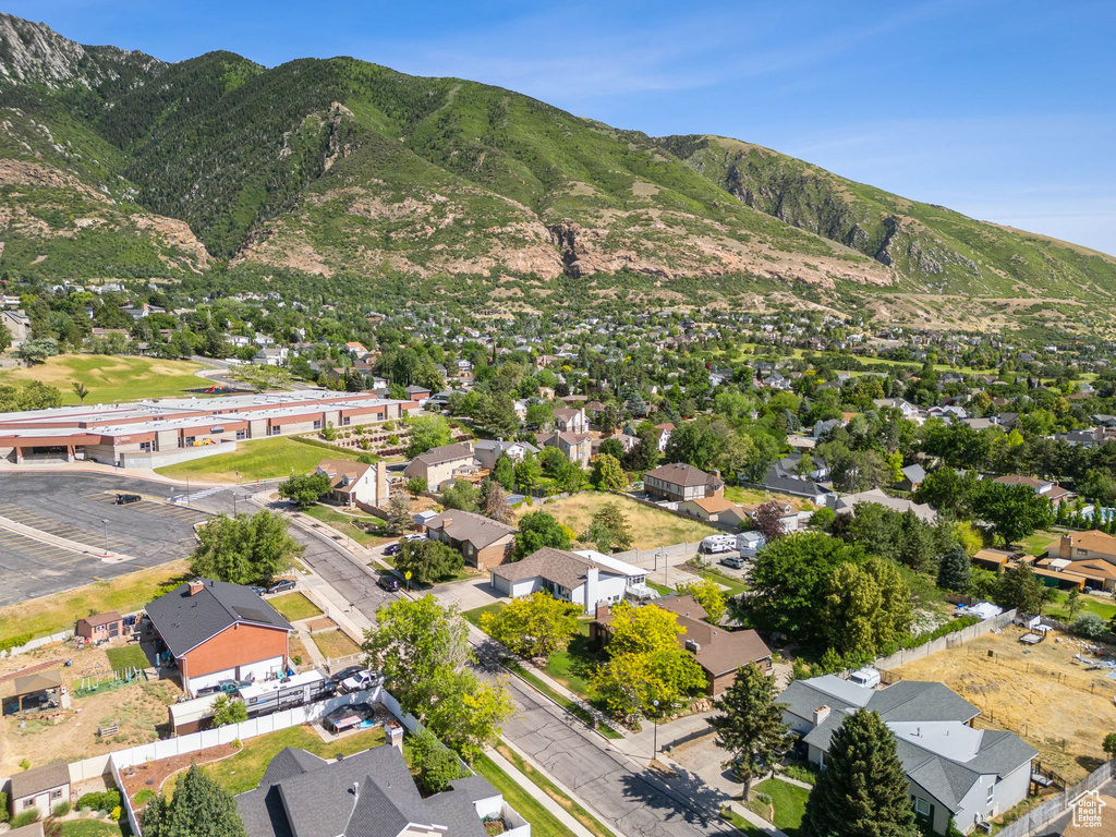 Aerial overview of property's location featuring a mountain backdrop and nearby suburban area