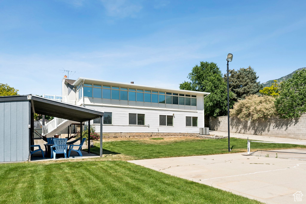 Rear view of house featuring stairway and a patio area