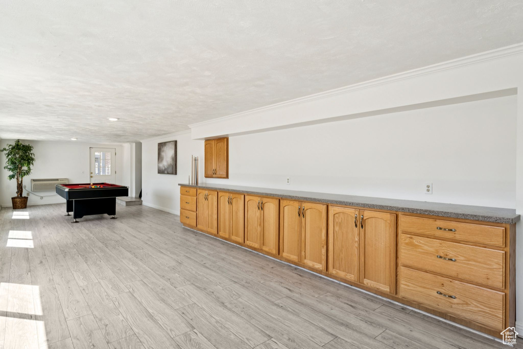 Rec room with billiards table, light wood-style floors, crown molding, and a textured ceiling