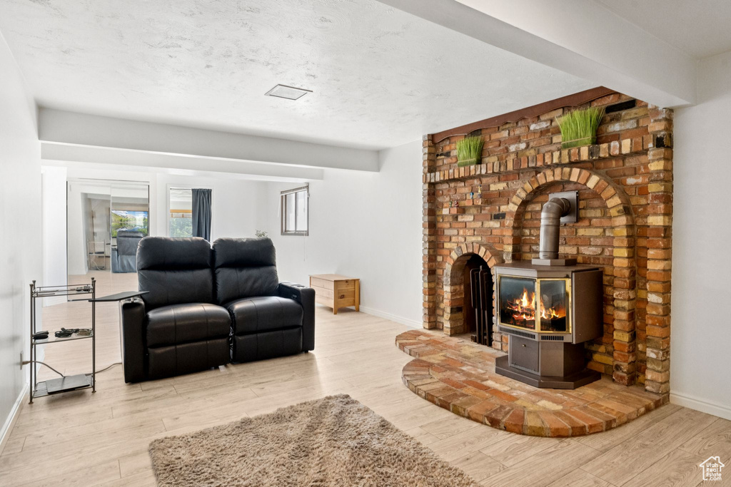 Living area with a wood stove and wood finished floors