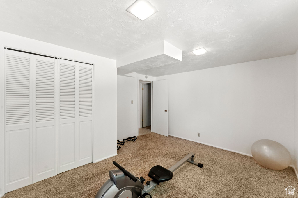 Workout area with carpet floors and baseboards