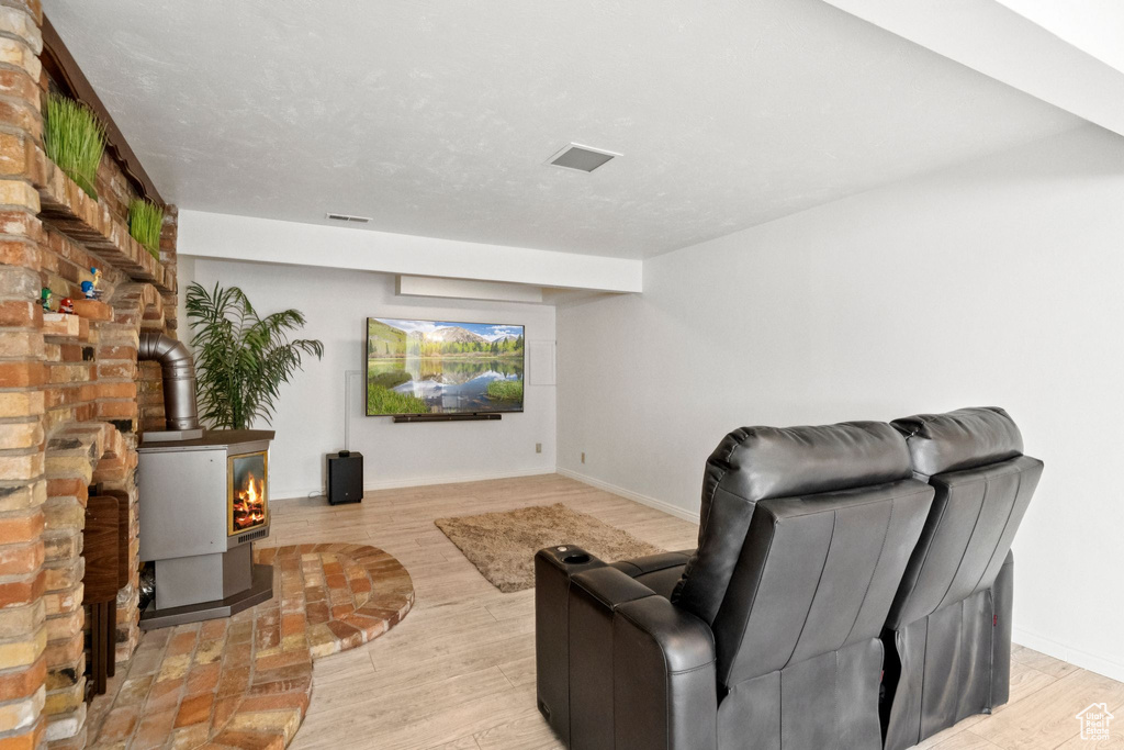 Living area with a wood stove and light wood-style floors