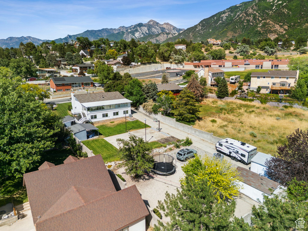 Aerial perspective of suburban area featuring a mountain backdrop
