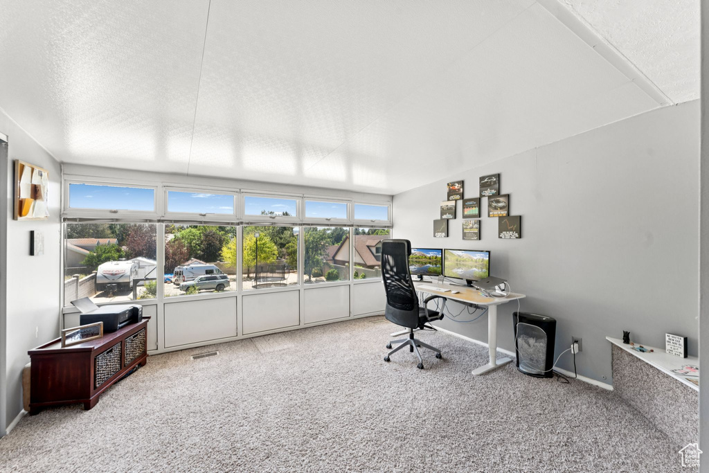 Carpeted office space featuring baseboards
