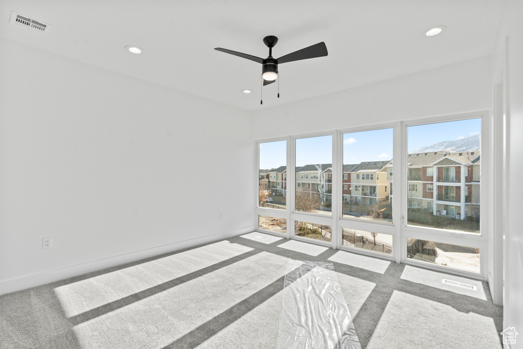 Spare room with carpet floors, recessed lighting, and ceiling fan