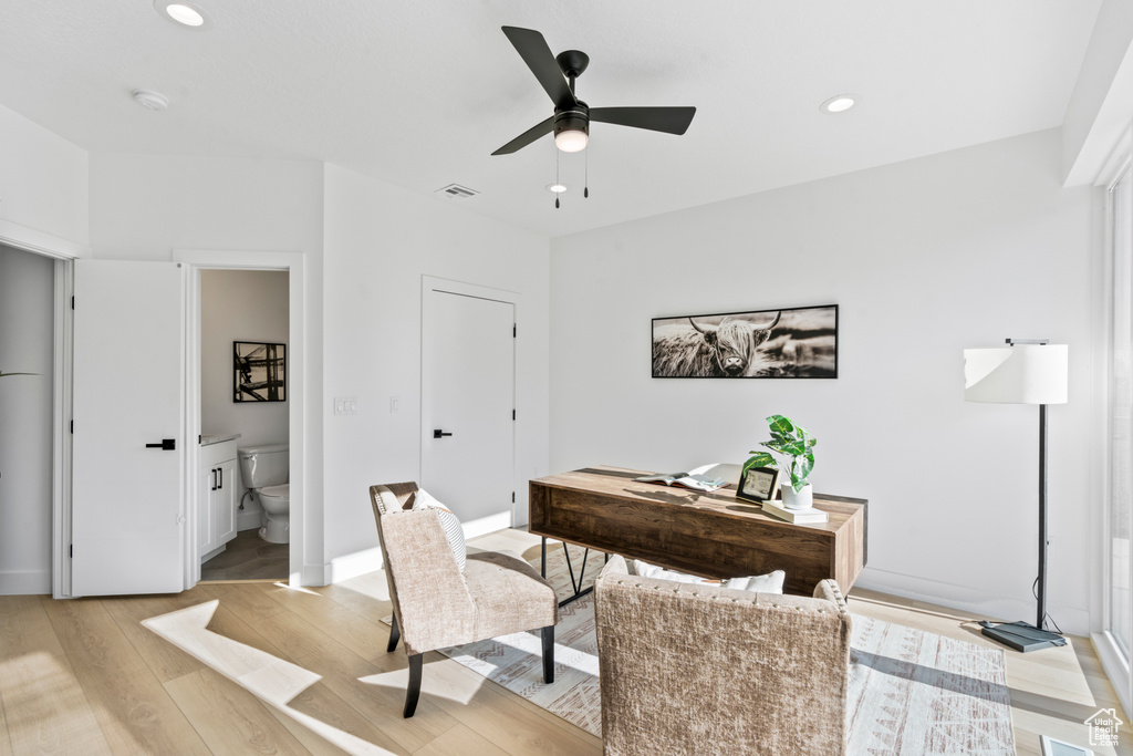 Office area featuring light wood-style flooring, ceiling fan, and recessed lighting