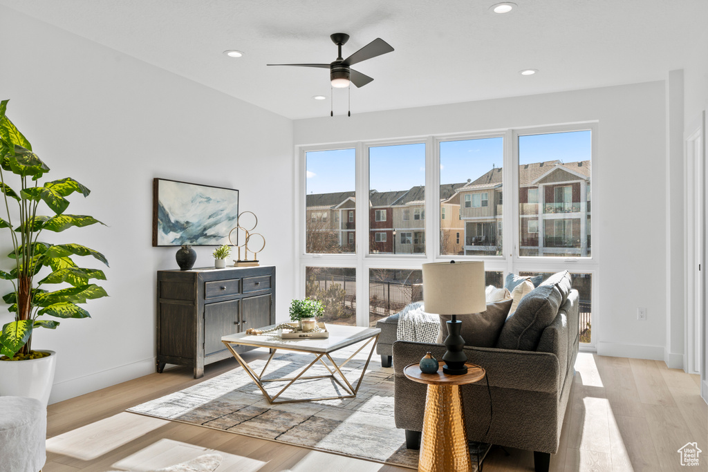 Living room featuring light wood finished floors, ceiling fan, and recessed lighting
