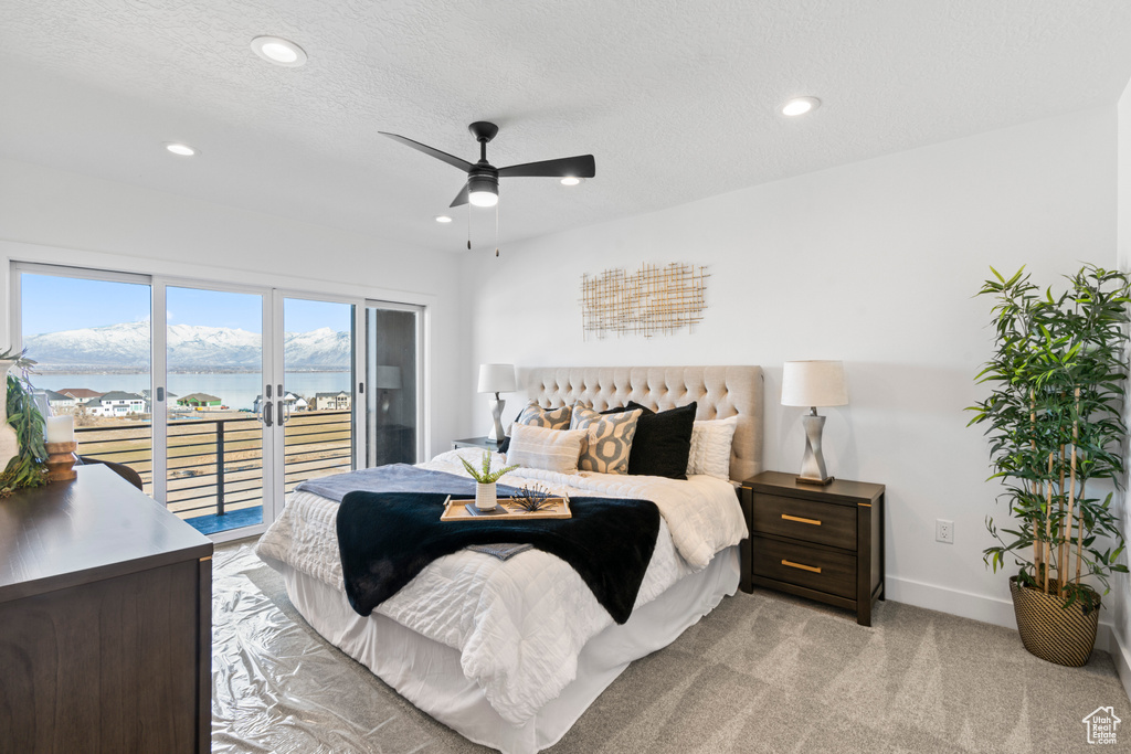 Bedroom featuring access to outside, recessed lighting, a water view, light colored carpet, and ceiling fan