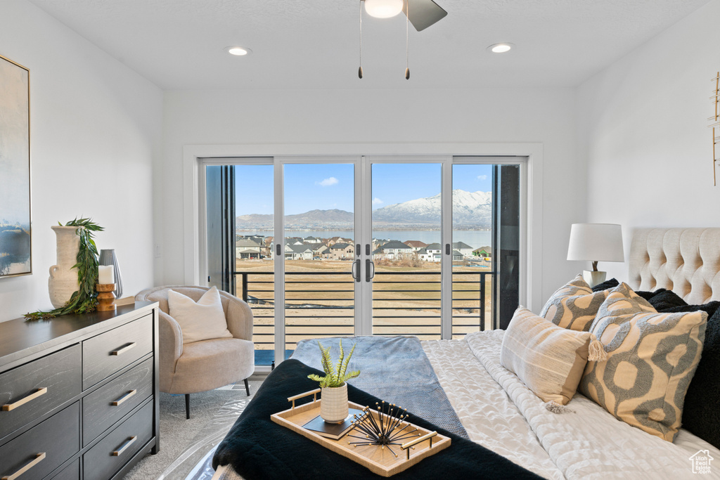 Bedroom featuring access to exterior, multiple windows, a mountain view, light carpet, and recessed lighting
