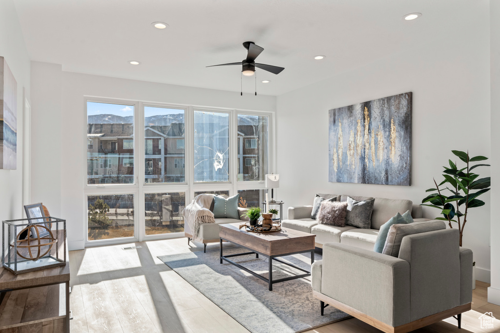 Living room featuring a ceiling fan, wood finished floors, and recessed lighting