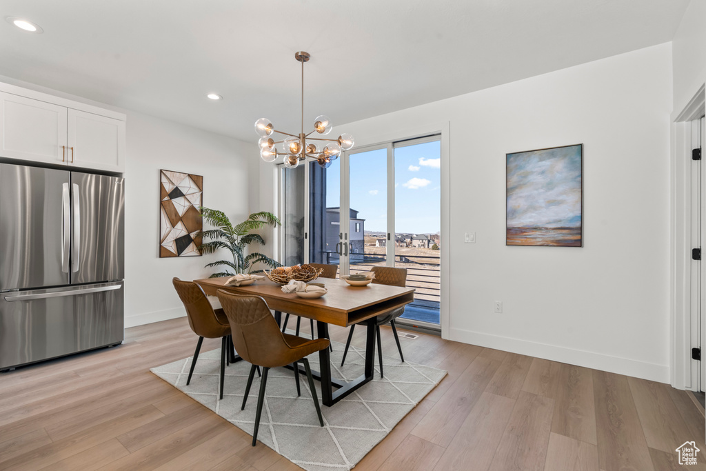 Dining area featuring a chandelier, light wood finished floors, and recessed lighting