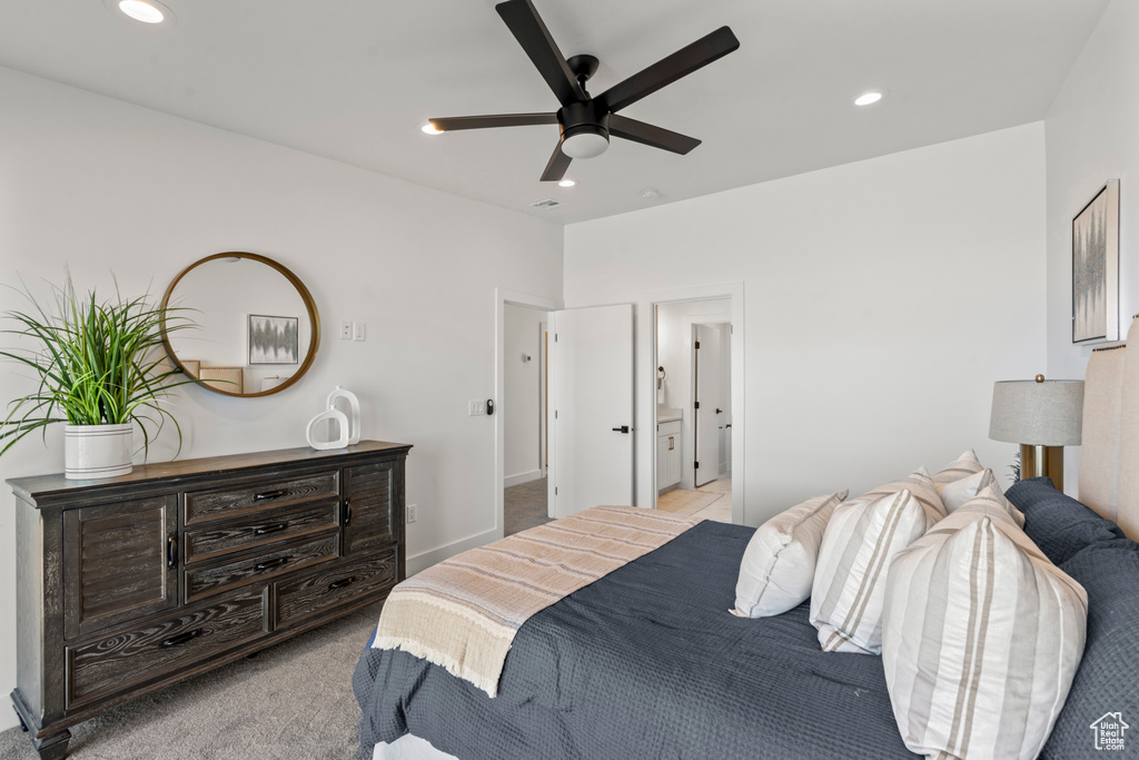 Bedroom with recessed lighting, light colored carpet, ensuite bathroom, and ceiling fan