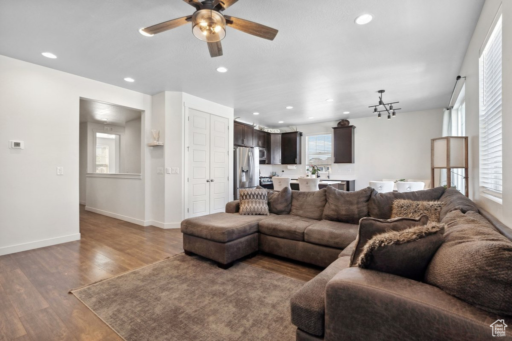 Living area featuring a ceiling fan, wood finished floors, and recessed lighting