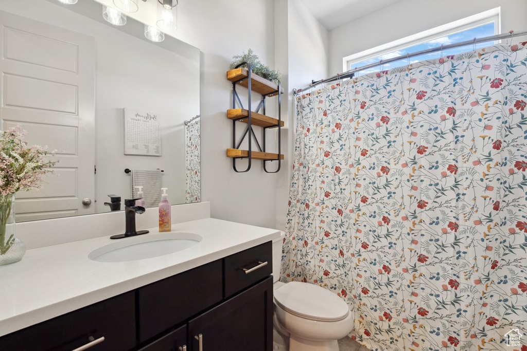 Bathroom with vanity and curtained shower