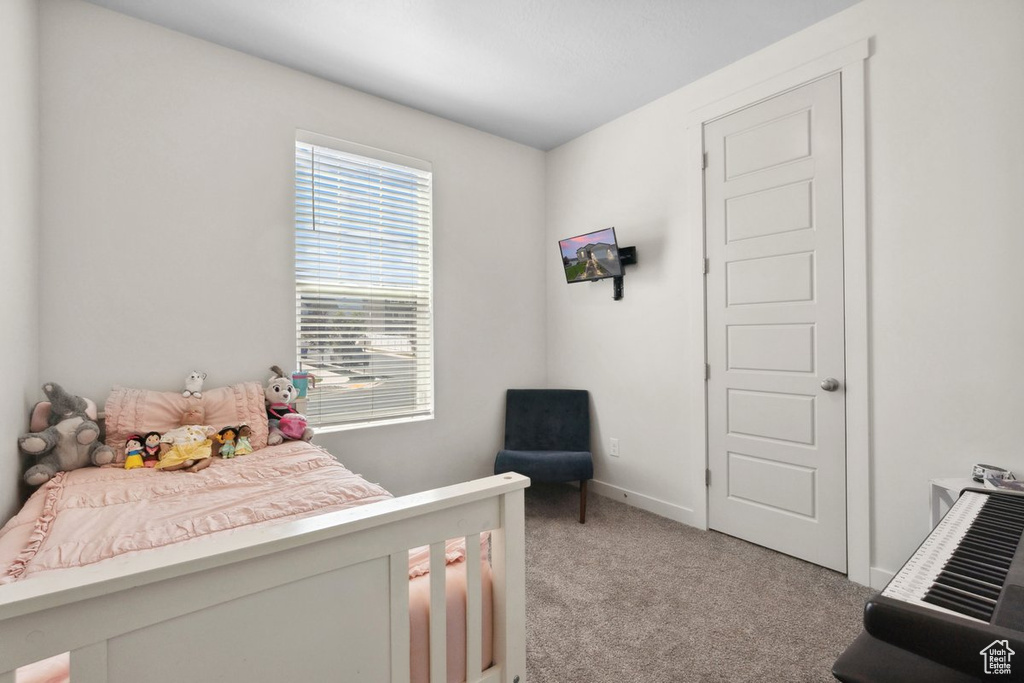 Bedroom with light carpet and baseboards