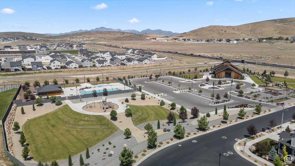 Aerial overview of property's location featuring a mountain backdrop and nearby suburban area