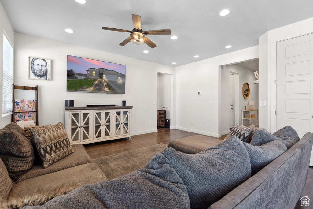 Living area featuring wood finished floors, a ceiling fan, and recessed lighting