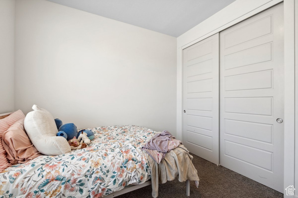 Bedroom featuring carpet floors and a closet