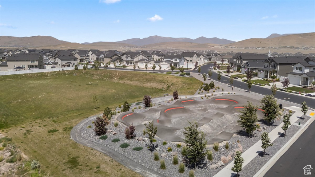 Aerial view of property\'s location featuring nearby suburban area and mountains