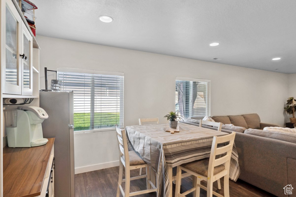 Dining area featuring dark wood-style floors and recessed lighting