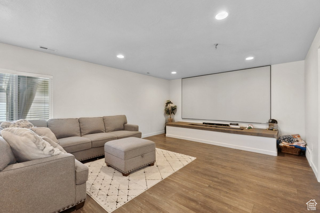 Cinema room with wood finished floors and recessed lighting
