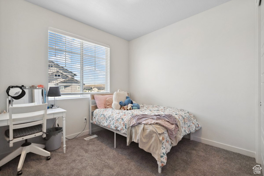 Bedroom featuring carpet flooring and an office area