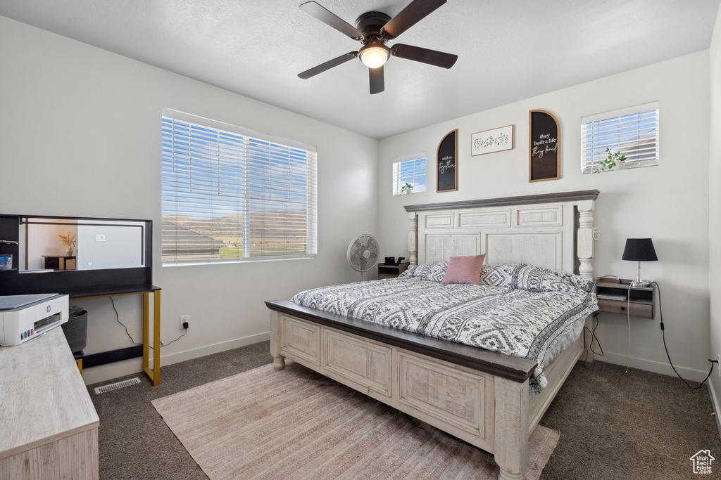 Bedroom featuring light carpet and ceiling fan