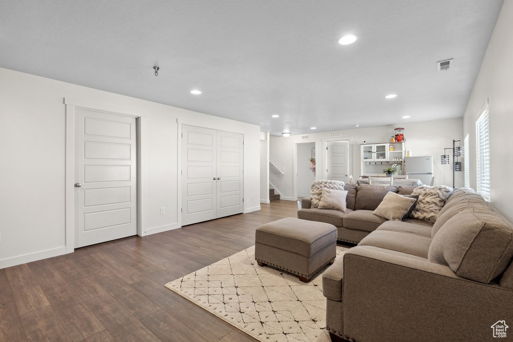 Living room featuring stairway, wood finished floors, and recessed lighting