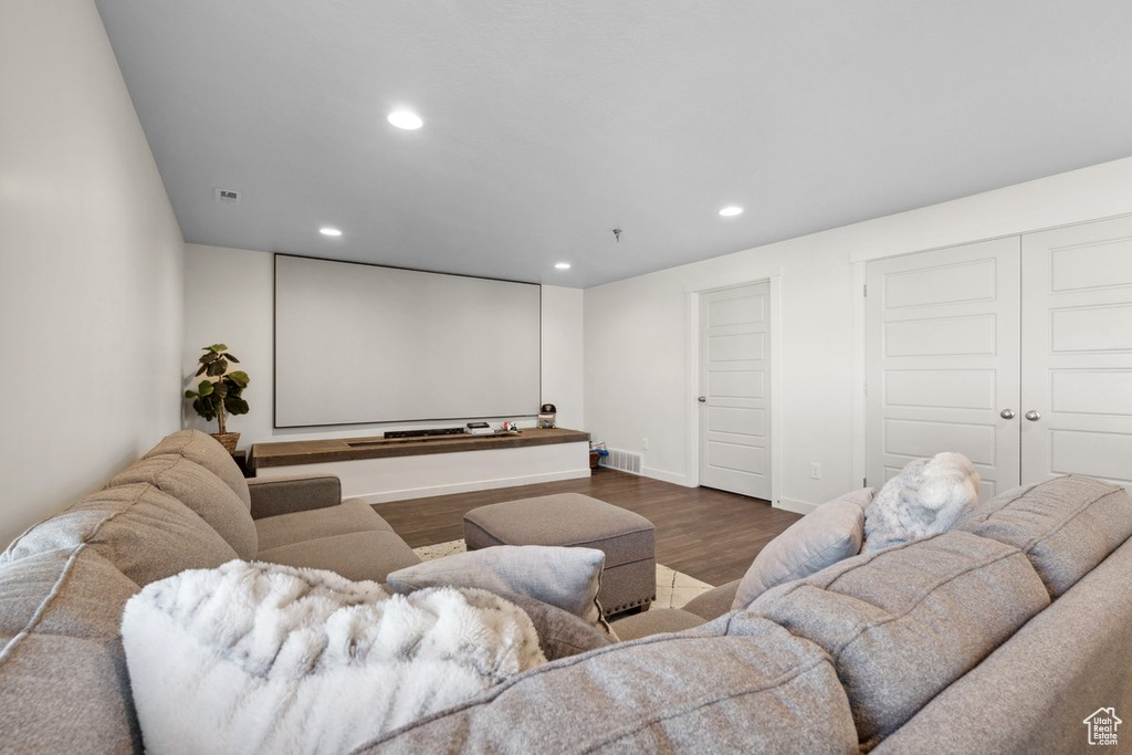 Home theater featuring recessed lighting and dark wood finished floors