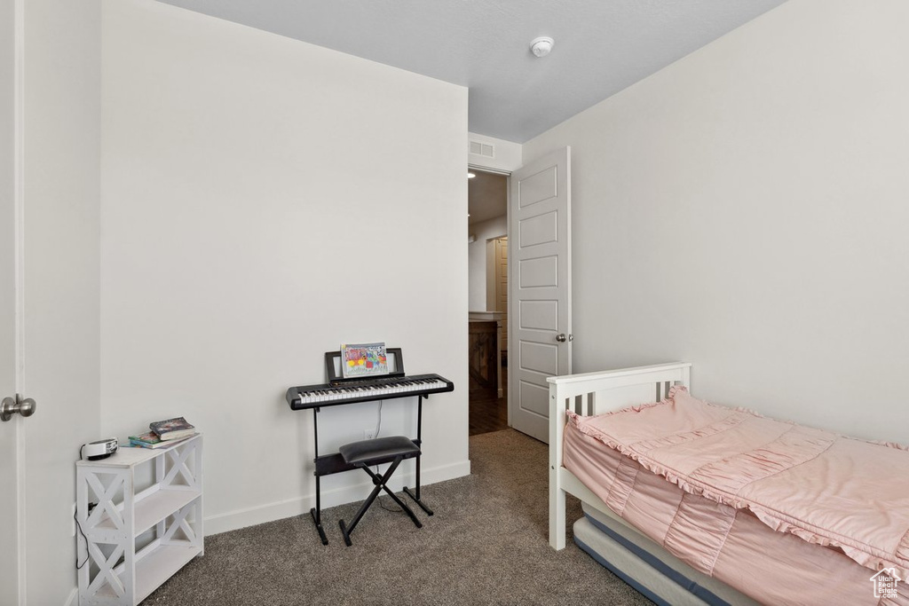 Carpeted bedroom featuring baseboards