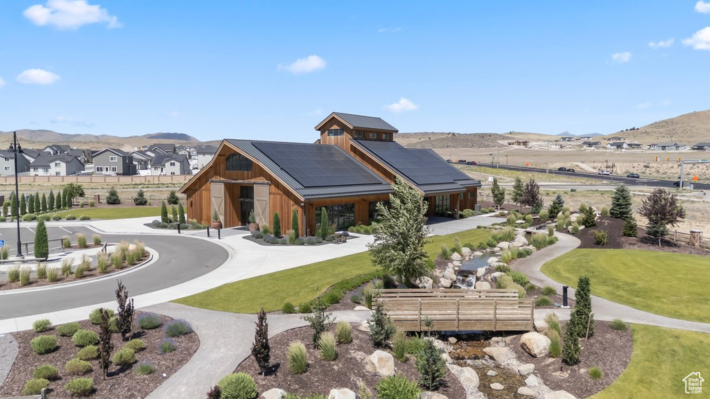Surrounding community with a mountain view and a lawn