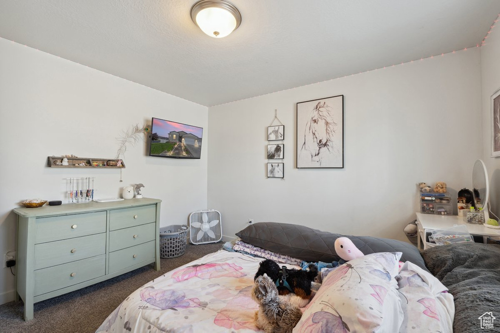 Bedroom featuring dark carpet