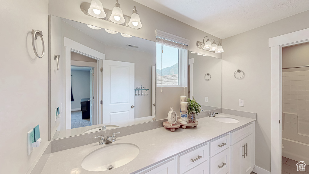 Bathroom with double vanity and toilet