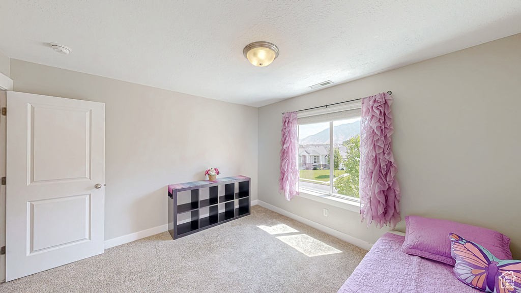 Bedroom featuring carpet floors and baseboards